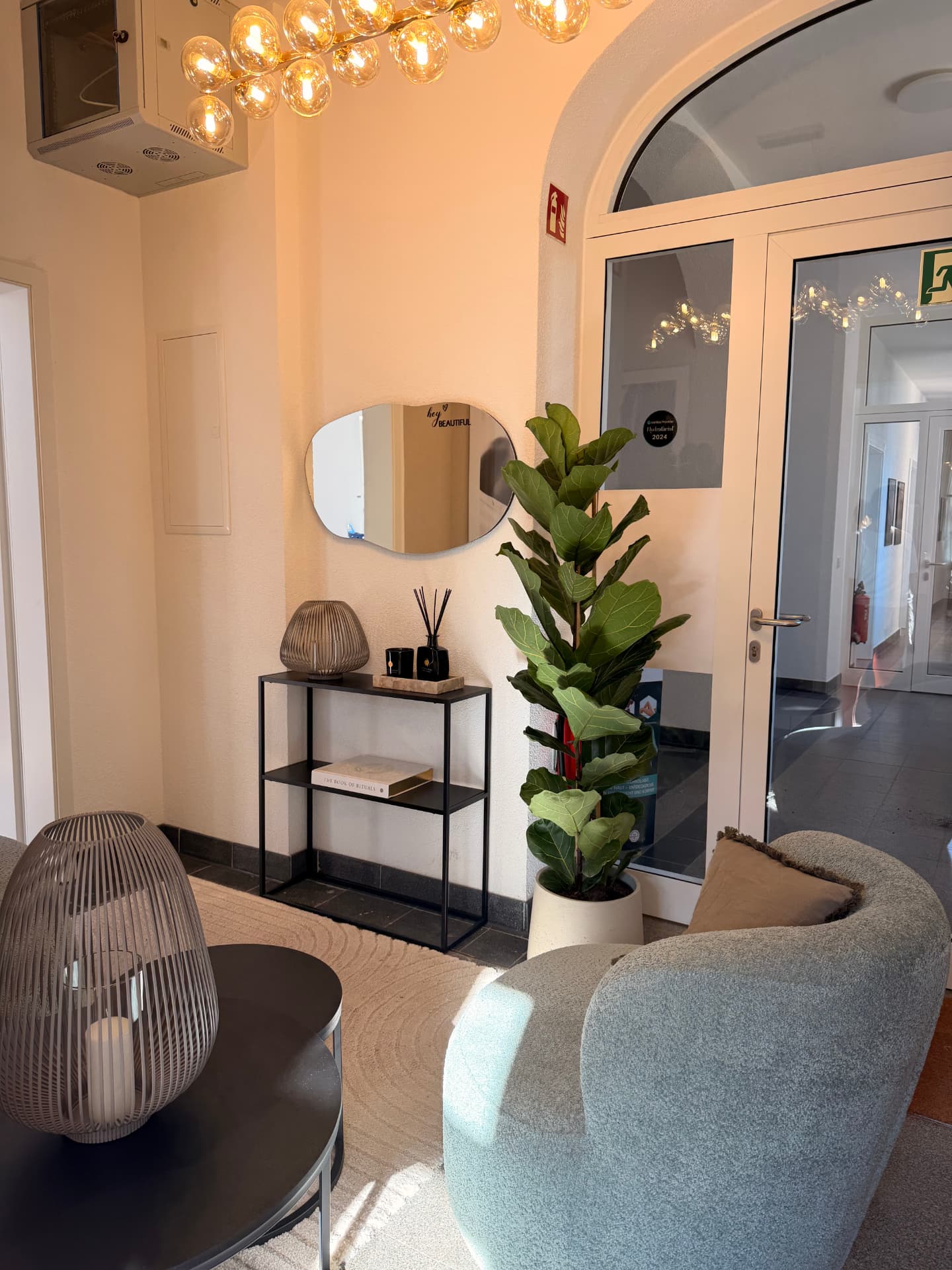 Wartebereich von Beauty Artistry Villingen mit Sessel und Leuchter